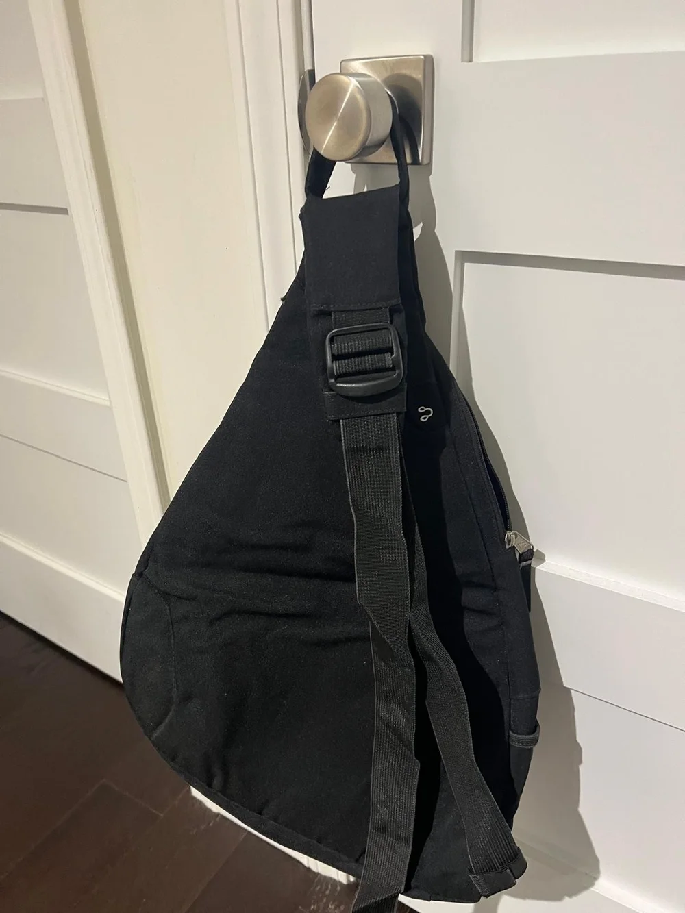 Jansport Black Sling Backpack with Front Zip Pocket
